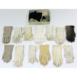 A pair of early 20th century seal-skin gloves; together with twelve pairs of various kid leather