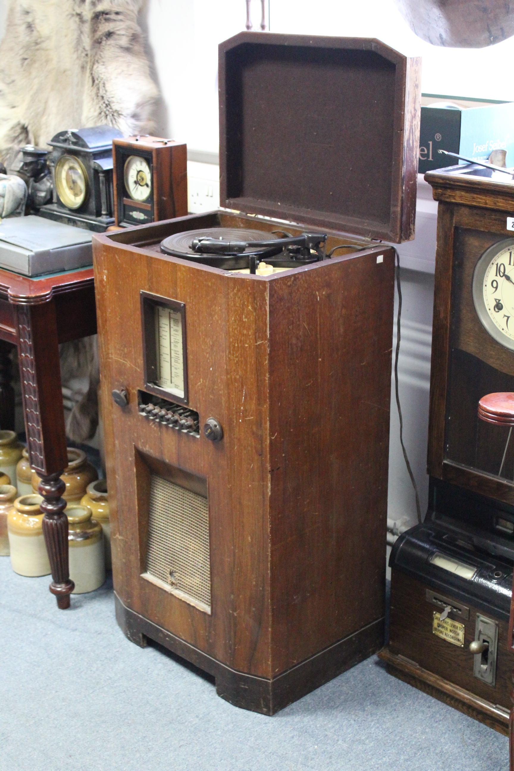 A mid-20th century floor-standing radiogram fitted Garrard turntable to the hinged lid, & in