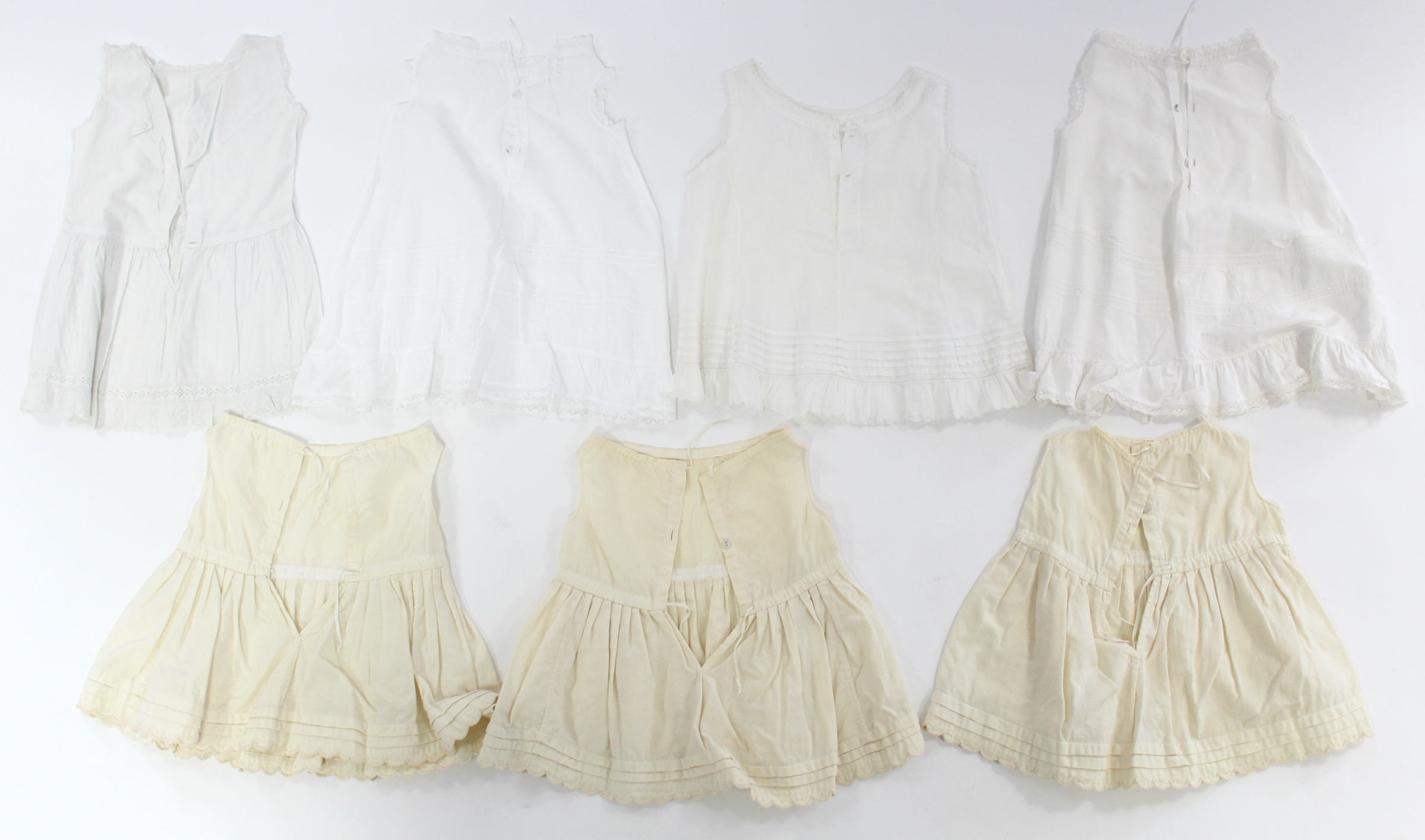 Twelve various early 20th century babies’ embroidered white cotton short gowns;