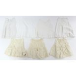 Twelve various early 20th century babies’ embroidered white cotton short gowns;