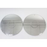 A pair of bevelled frameless circular wall mirrors, 27¾” diameter.