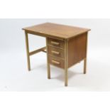 A small oak kneehole desk, fitted brushing slide above three long drawers to the right-hand