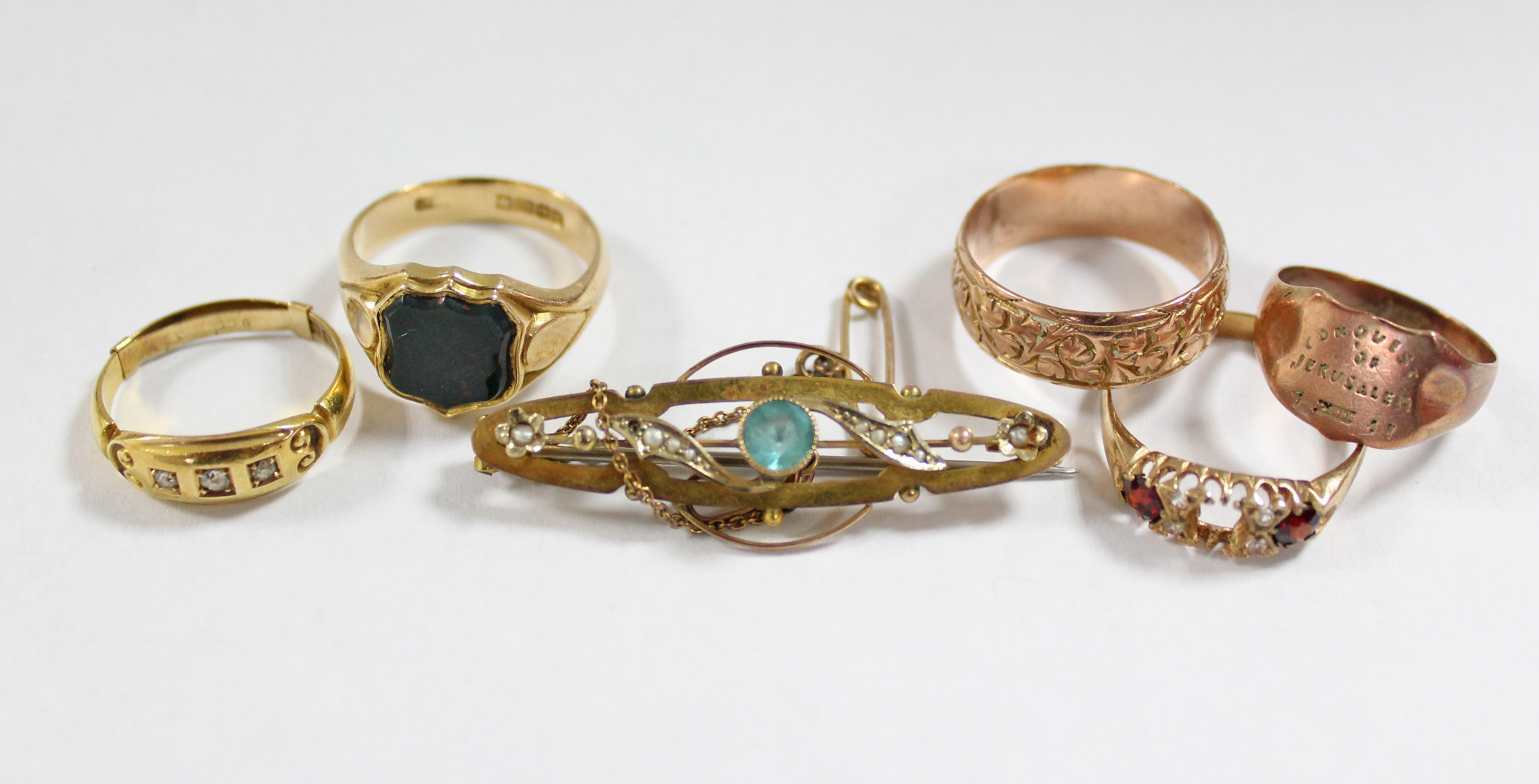 Two 18ct. gold dress rings; & a yellow-metal bar brooch.