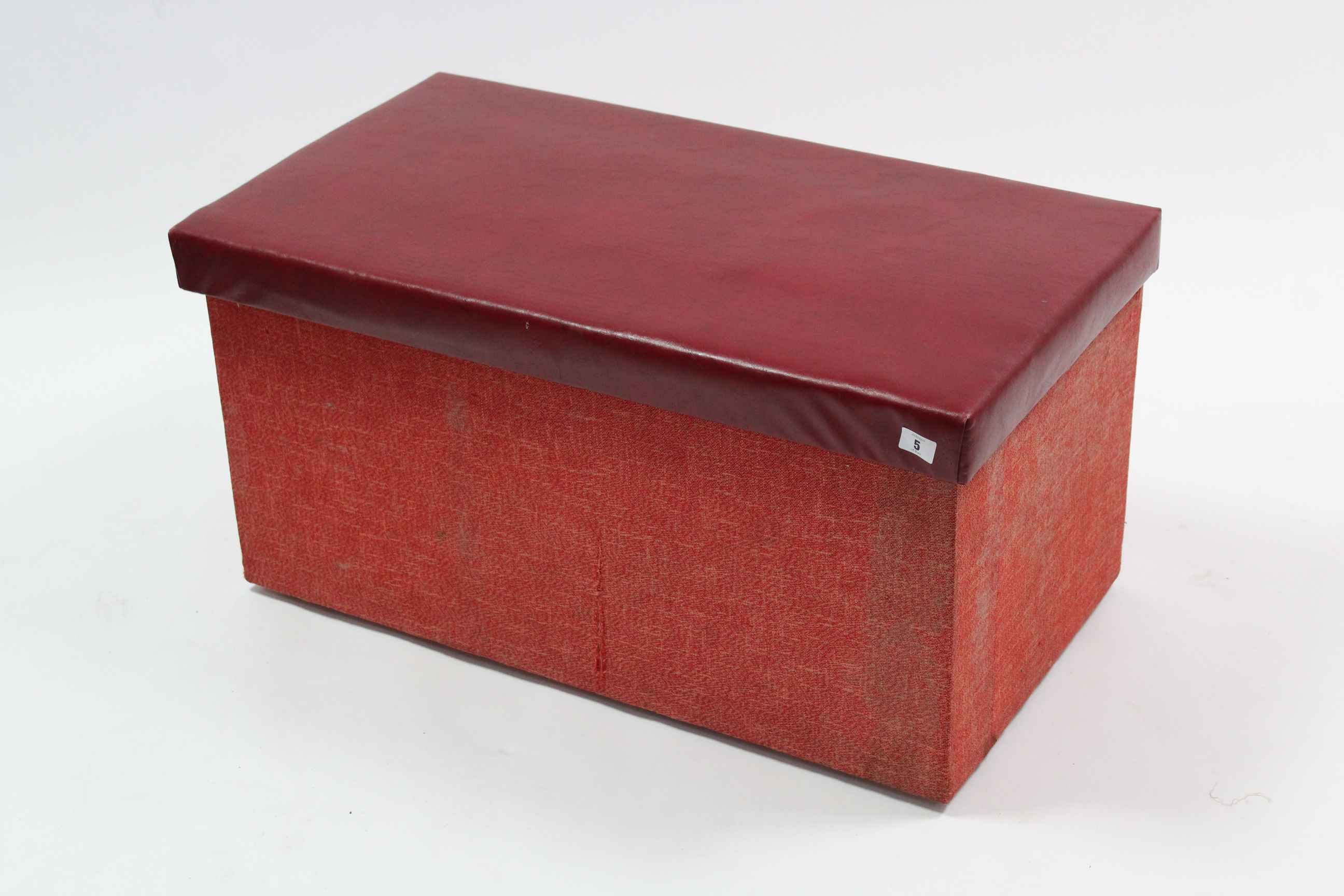A crimson upholstered box ottoman with hinged lift-lid, 31” wide.