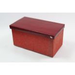 A crimson upholstered box ottoman with hinged lift-lid, 31” wide.