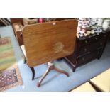 A 19th century mahogany tripod table with rounded corners to the rectangular tilt top, & on vase-