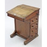 A 19th century inlaid-walnut davenport (lacking leather cloth), enclosed by fall-front, & fitted