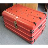 A crimson & black painted tin trunk with hinged lift-lid & with wrought-iron side handles, 30”