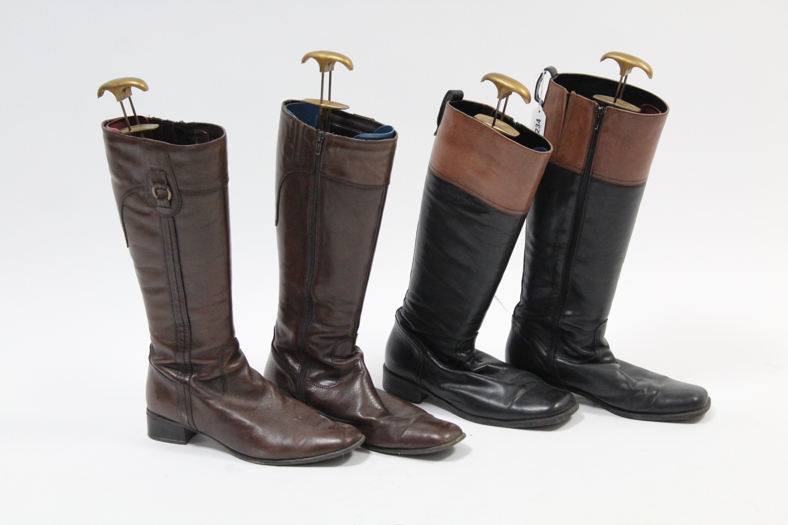 Two modern pairs of ladies leather riding boots, with trees.