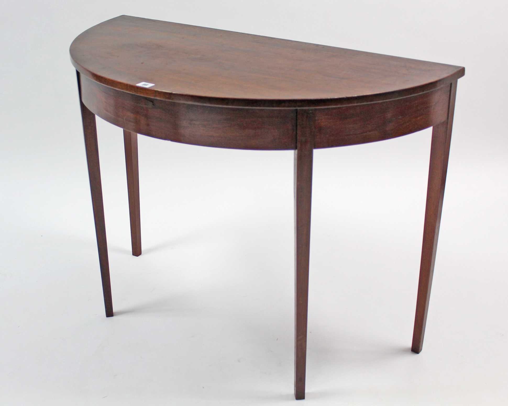 A mahogany demi-lune side table on square tapered legs, 37½” wide; together with a pair of oak