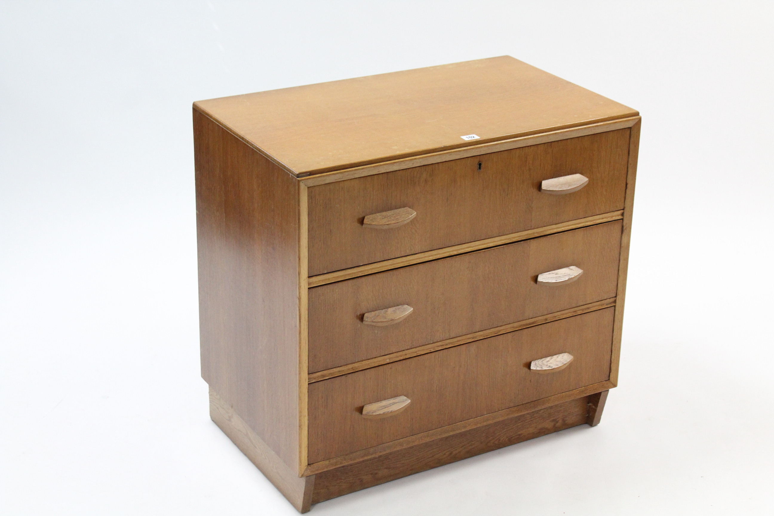 A Hunts light oak small chest, fitted three long drawers with block handles, & on plinth base, 30”