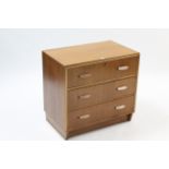 A Hunts light oak small chest, fitted three long drawers with block handles, & on plinth base, 30”
