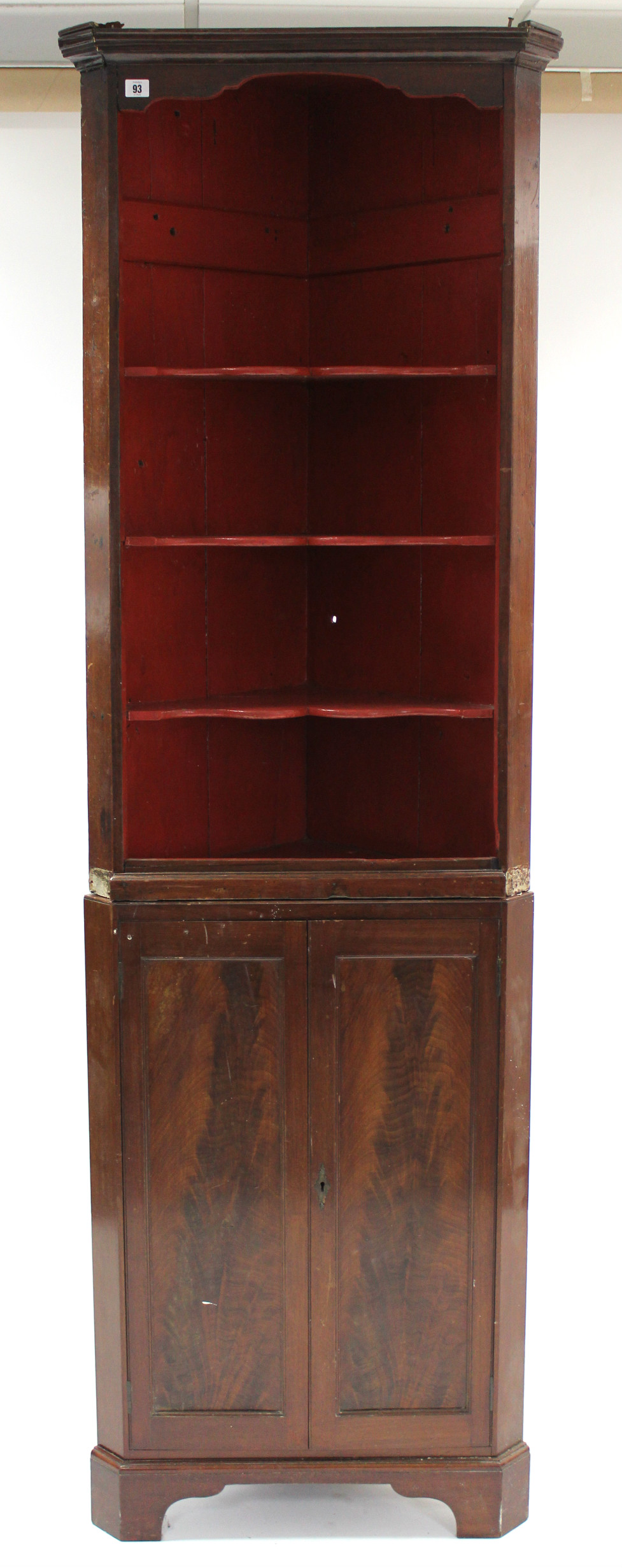 A 19th century mahogany tall standing corner cabinet, fitted three shaped open shelves above