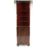 A 19th century mahogany tall standing corner cabinet, fitted three shaped open shelves above