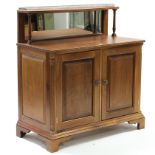 A Victorian style mahogany chiffonier with brass gallery to the low mirror back, enclosed pair of