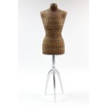 A wicker mannequin on chrome-finish stand.