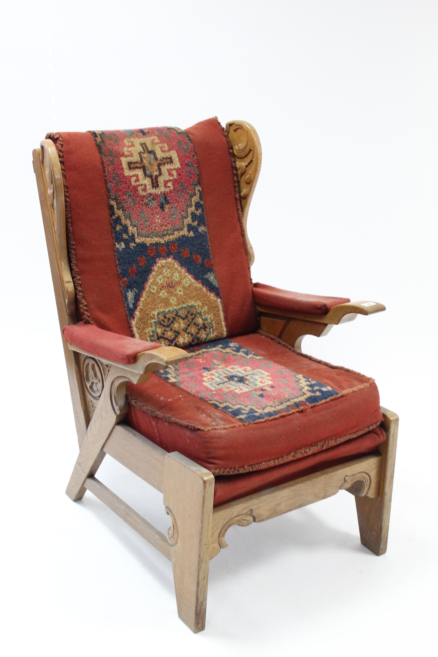 A carved oak frame armchair upholstered Kelim fabric, & on shaped legs with plain stretchers.