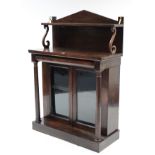 A Victorian rosewood chiffonier with open shelf to the low-stage panel back, fitted cushion-