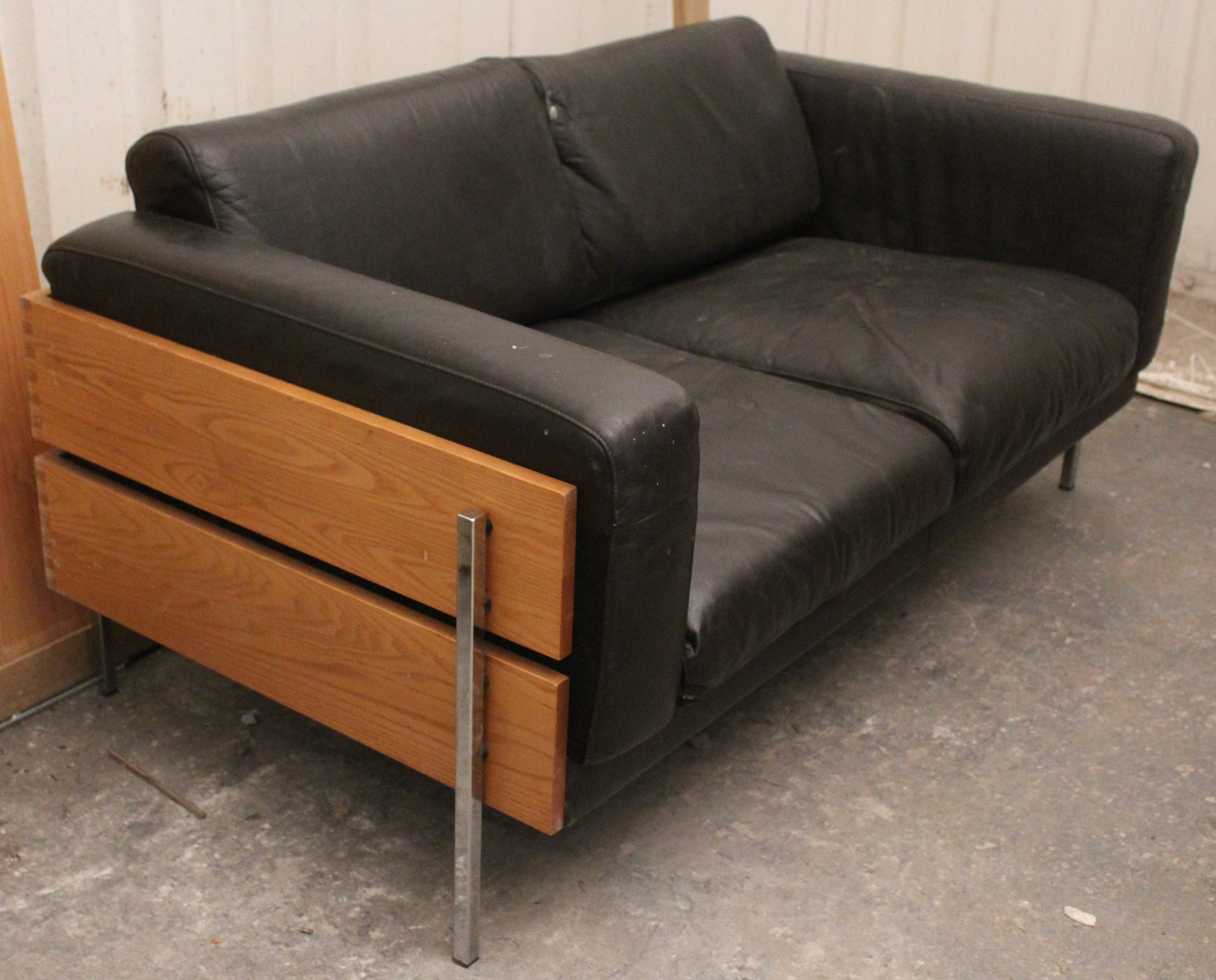 A Habitat brown leatherette & pine frame two-seater settee after a design by Robin Day, 59” long.