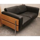A Habitat brown leatherette & pine frame two-seater settee after a design by Robin Day, 59” long.
