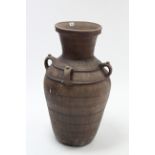 A large terracotta olive oil pot of ovoid form, 34½” high.