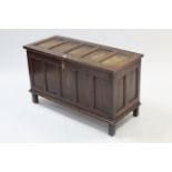 A late 19th/early 20th century small oak coffer with hinged lift-lid, with panelled front & sides, &