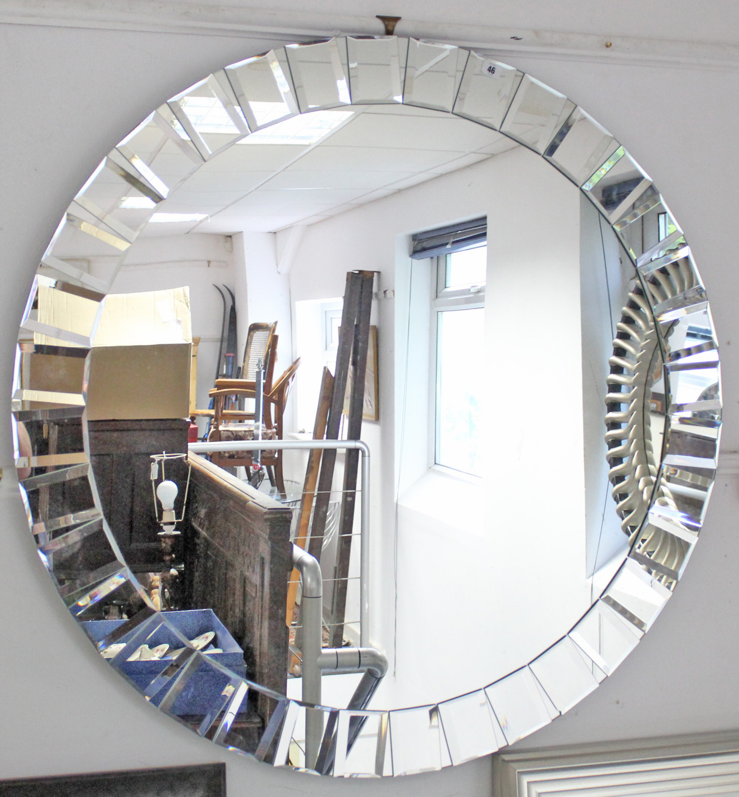 A similar large circular wall mirror with bevelled segmented border, 43½” diameter.