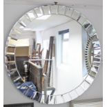 A similar large circular wall mirror with bevelled segmented border, 43½” diameter.