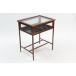 An Edwardian inlaid-mahogany bijouterie table enclosed by glazed hinged lift-lid, with glazed sides,