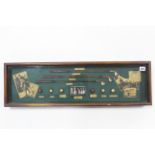 A replica display titled: “The History of Golf”, 9½” x 31½”, in glazed wooden case.