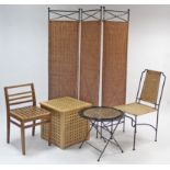 A wrought iron & rattan three-fold draught screen; a similar circular patio table & chair; & a