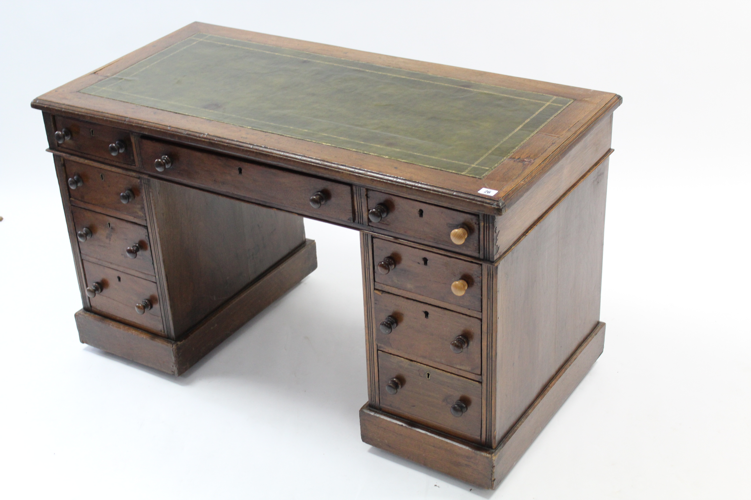 A Victorian mahogany pedestal desk inset gilt-tooled green leather cloth, fitted with an arrangement