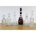 A ruby overlaid cut-glass mallet-shaped decanter with finial stopper, 15¾” high; & five other cut-