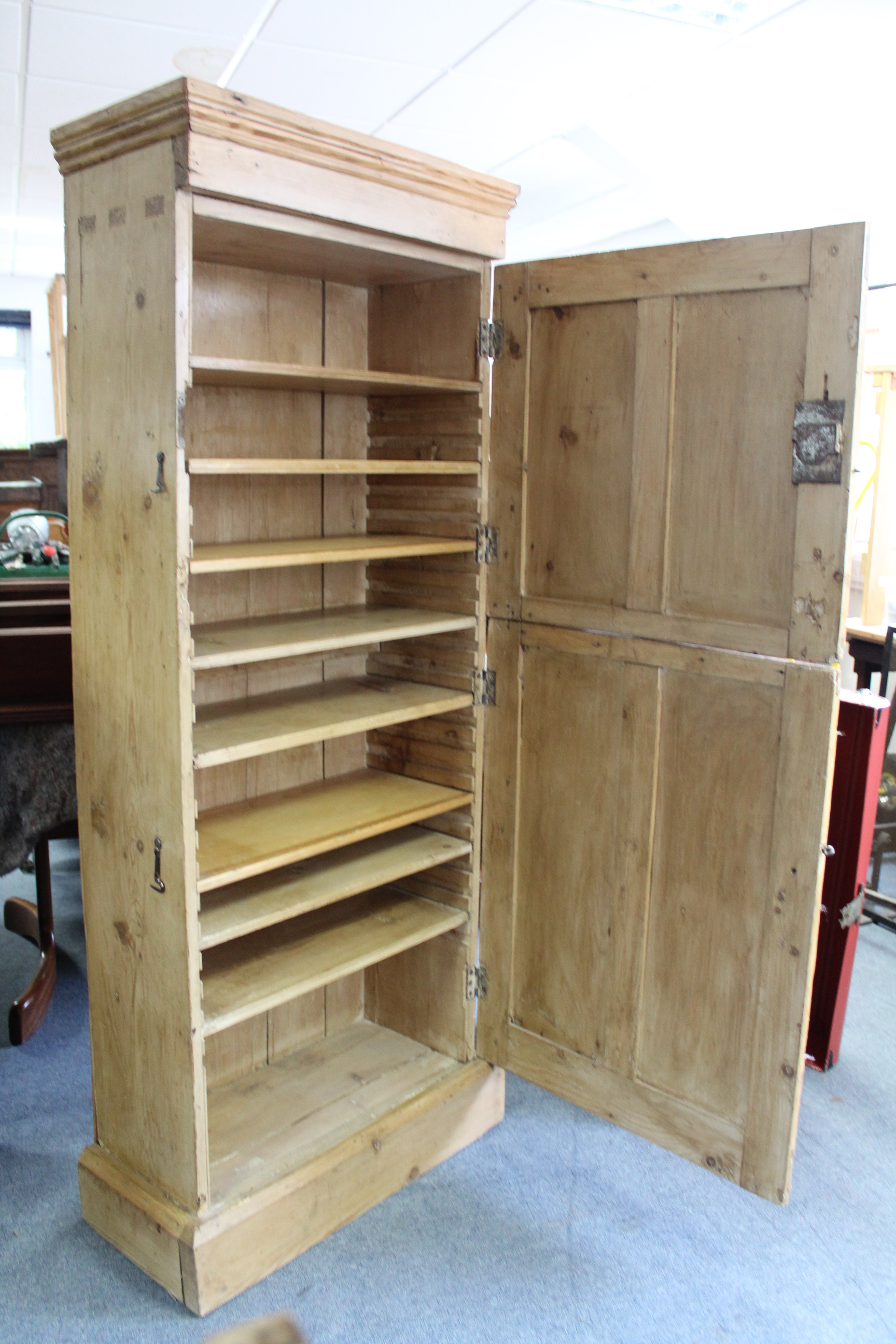 A Victorian pine tall cupboard with eight adjustable shelves enclosed by two panel doors, & on - Image 2 of 3