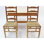 A pair of pine ladder-back dining chairs with woven rush seats, & on square tapered legs; & a pine