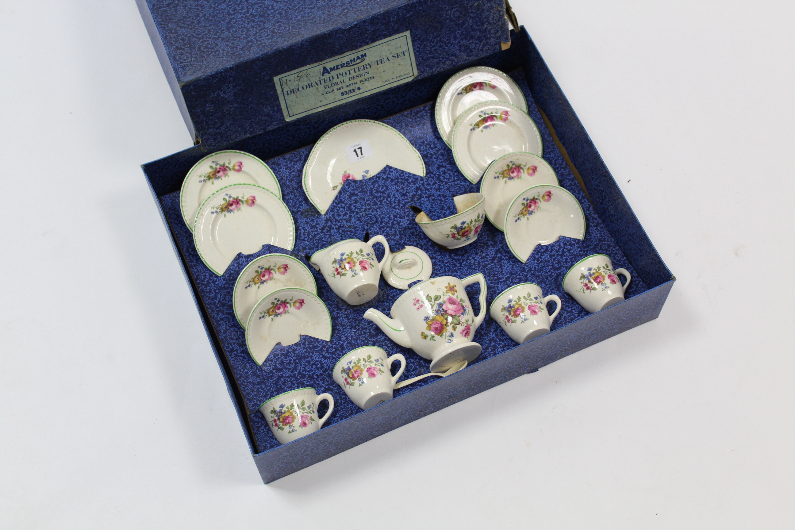 An early-mid-20th century child’s sixteen-piece floral tea service (settings for four), boxed.