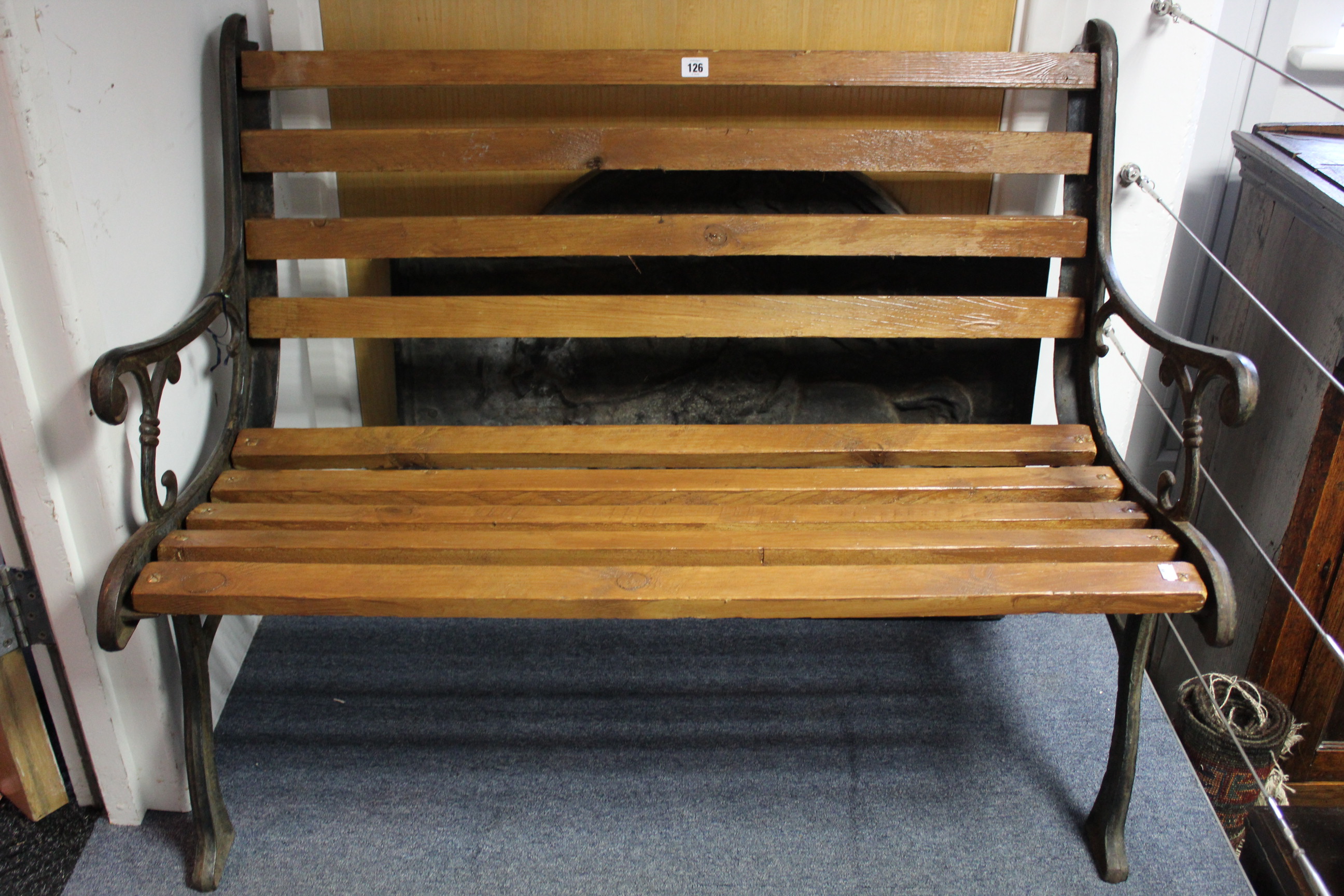 A cast-iron & pine slatted garden bench, 42” long.