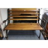 A cast-iron & pine slatted garden bench, 42” long.