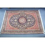A Persian pattern rug of deep blue & crimson ground & with all-over repeating floral & scroll