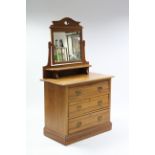 A late Victorian walnut dressing chest with rectangular swing mirror to the stage back, fitted three