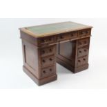 A Victorian mahogany pedestal desk inset gilt-tooled green leather cloth, fitted with an arrangement