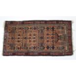 A Persian rug of peach ground, with all-over repeating geometric design within multiple borders;