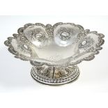 A late Victorian silver embossed sweetmeat dish of lobed circular form with scalloped-edge &