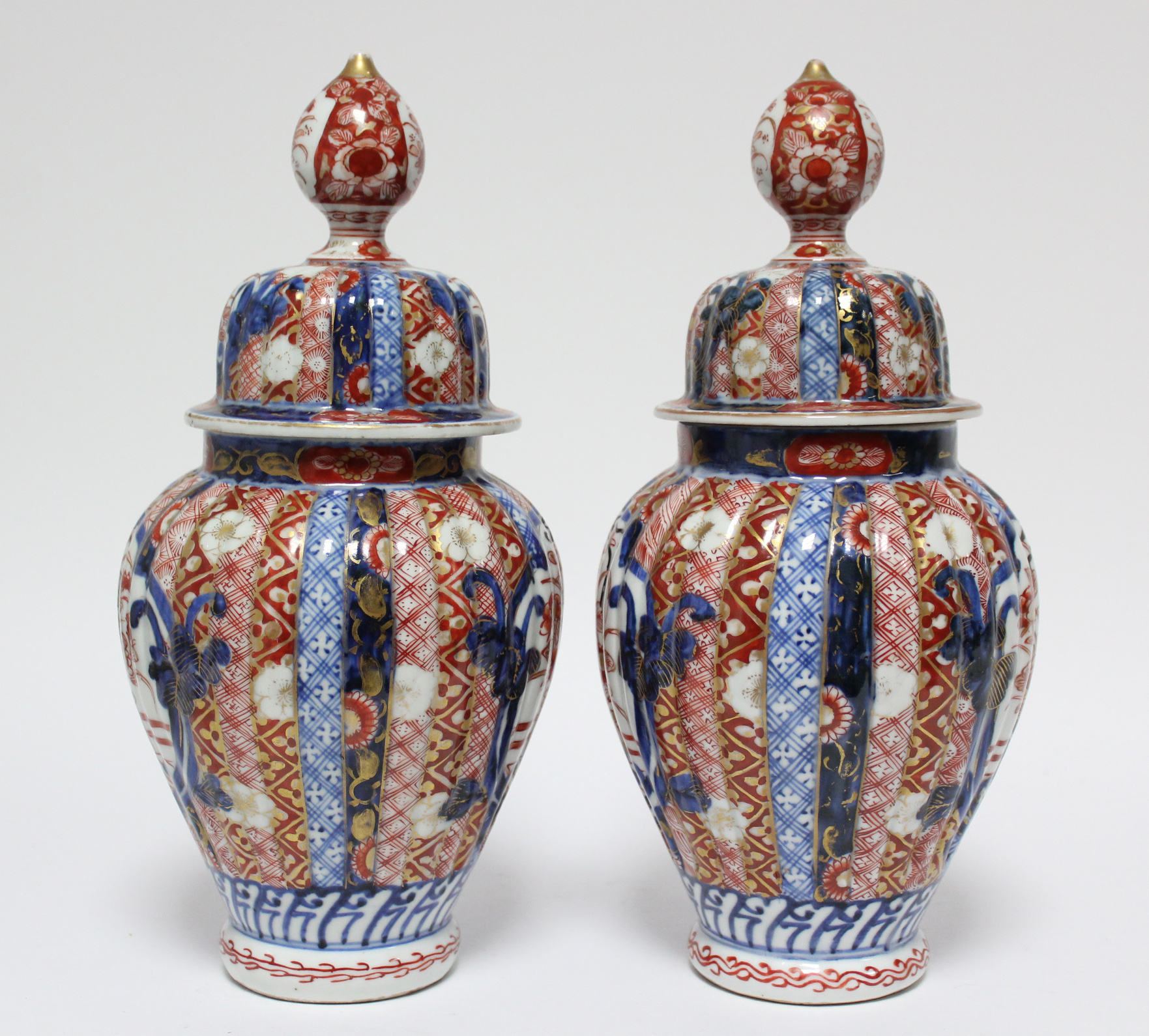 A pair of 19th century Japanese Imari fluted baluster vases with domed covers; 12” high. - Image 2 of 8