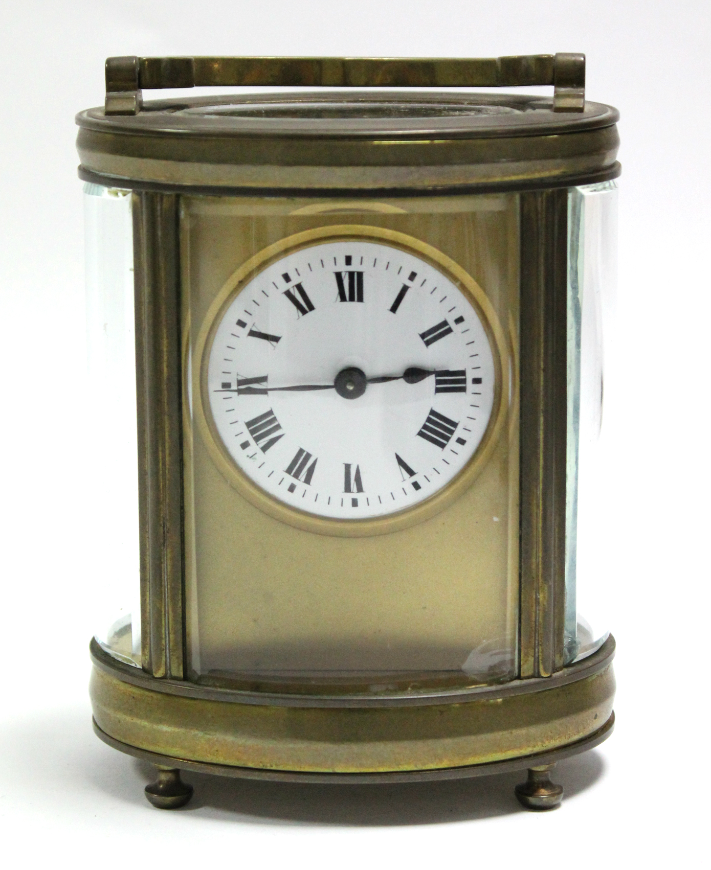 A French brass oval carriage timepiece by Duverdry & Bloquel, the 1¼” diam. white enamel dial with