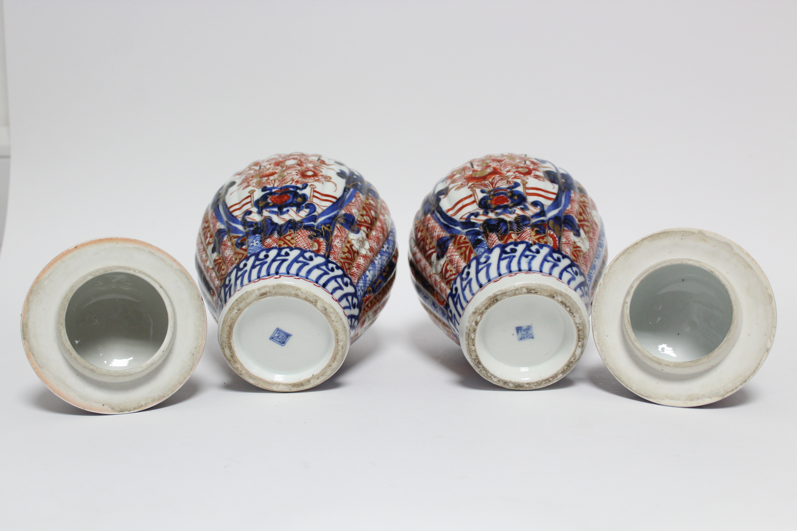 A pair of 19th century Japanese Imari fluted baluster vases with domed covers; 12” high. - Image 6 of 8