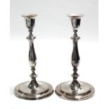 A pair of late 18th century Sheffield candlesticks with vase-shaped nozzles, slender baluster