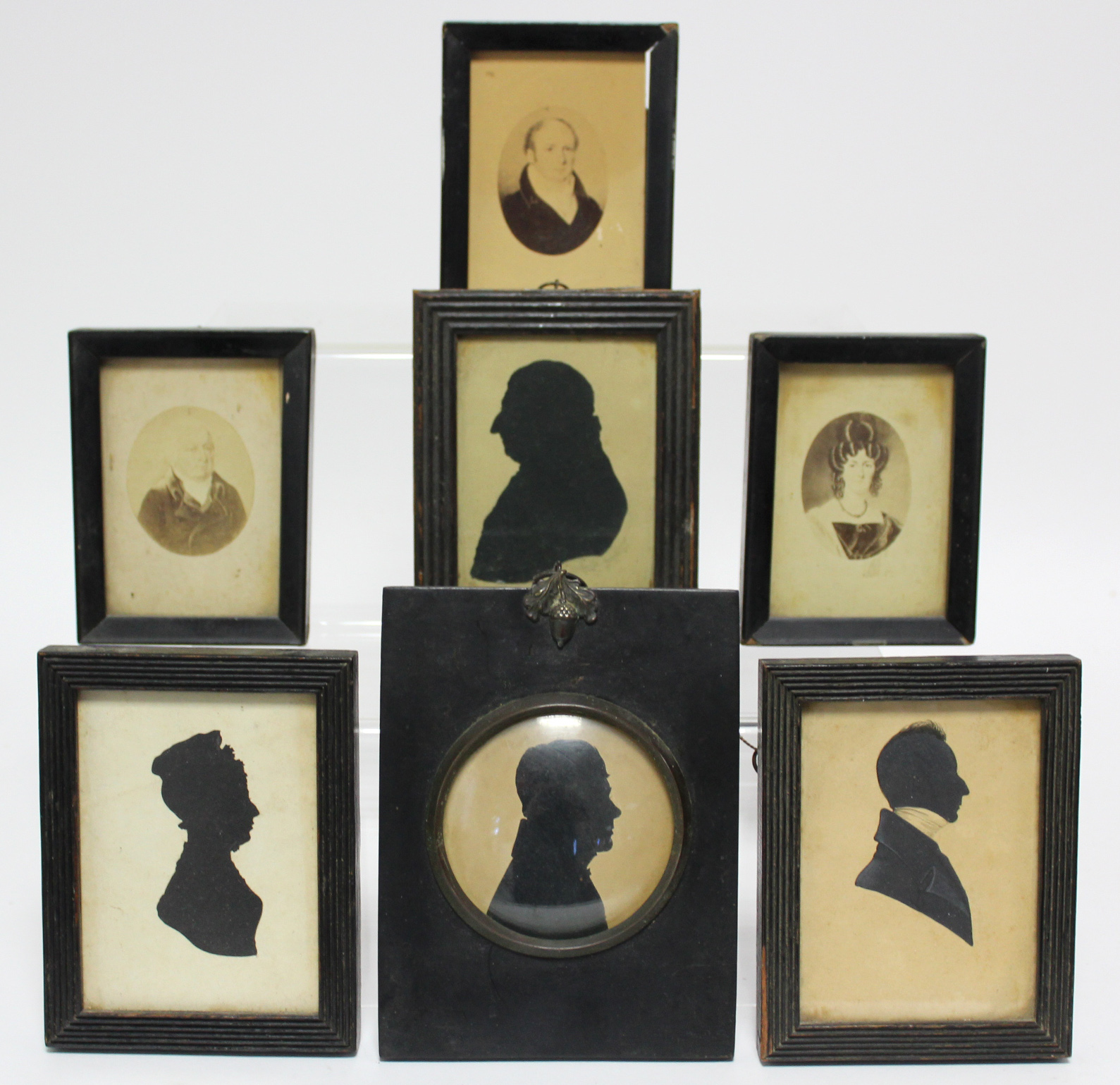 A 19th century silhouette portrait of a gentleman, 3” diam.; three other 19th century silhouette