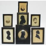 A 19th century silhouette portrait of a gentleman, 3” diam.; three other 19th century silhouette