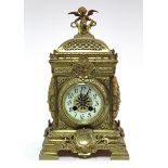 A late 19th century French brass mantel clock with Arabic numerals to the 4” cream enamel dial,